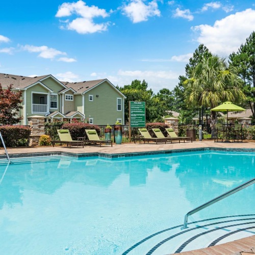a swimming pool with a house in the background