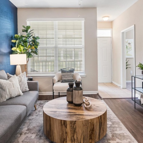 a living room with a ceiling fan and a couch